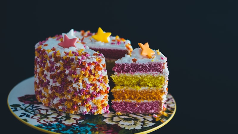 A rainbow layer cake on a cake stand